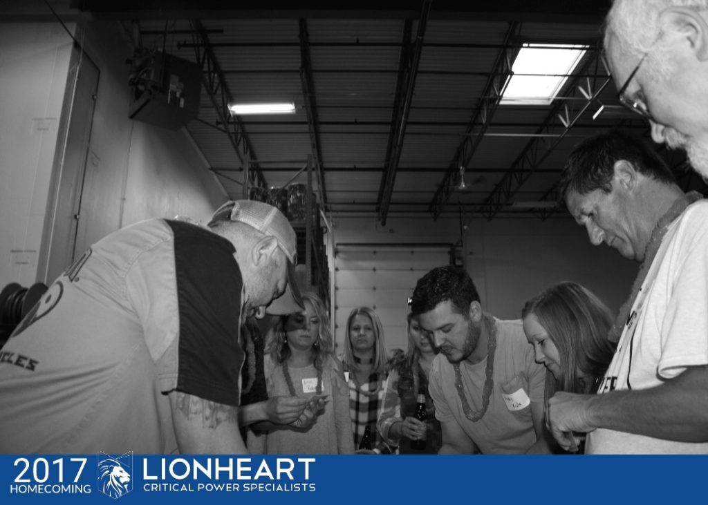 employees gathered in a circle during the 2017 lionheart homecoming