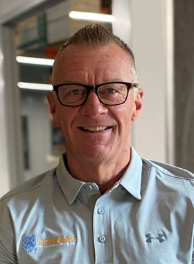 smiling employee in glasses and grey polo